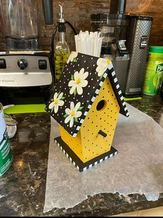 a birdhouse made out of cardboard sitting on top of a counter