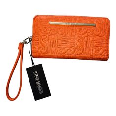 Steve Madden New With Tags Orange Detachable Wristlet Stamped Logo Gold Zipper And Brand Plate Wallet Has Three Sections For Credit Cards, Zippered Inside/Divider Center Pocket, And Is Large Enough To Hold A Cell Phone. See Photos Measures Approximately 8 X 5 X 1 Inches. Orange Logo, Steve Madden Bags, A Cell, Gold Zipper, Orange Gold, Credit Cards, Steve Madden, Divider, Cell Phone