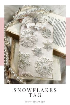 an old book with pearls and snowflakes on it