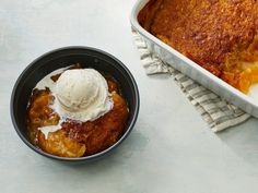 a casserole dish with ice cream in it next to a bowl of pudding