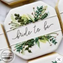 decorated cookies with the words bride to be written on them and surrounded by greenery