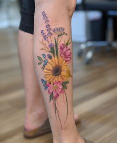 a woman's leg with flowers on it