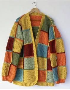 a multicolored cardigan sweater hanging on a hanger