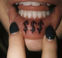 a woman's mouth with dollar signs on it and two fingers in front of her