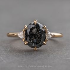 a black and white diamond ring with gold accents