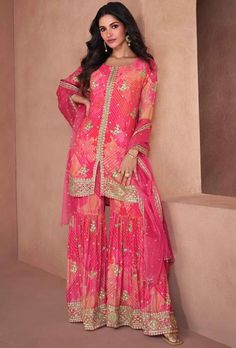 Elegant Pink Georgette Suit Set for Wedding & Partywear - Size 38 This attire is Enhanced with Digital, Floral Print, Zari and Sequins Work . Crafted in Round Neck and Quarter Sleeve Description: Step into the spotlight with our exquisite Pink Georgette Suit Set, crafted to perfection for wedding occasions and glamorous parties. This Pakistani suit ensemble exudes sophistication and charm, tailored from premium Georgette fabric with meticulous attention to detail. Radiate elegance with every step as you adorn this trendy outfit, perfect for making a statement at any special event. Features: Material: High-quality Georgette fabric for a luxurious feel and graceful drape. Color: Enchanting Pink hue that adds a touch of femininity and allure. Style: Traditional yet trendy Pakistani suit desig Party Wear Salwar Suits, Pink Sharara, Orange And Hot Pink, Gharara Suits, Party Wear Salwar, Designer Salwar Kameez, Latest Salwar Kameez, Gown Suit, Indian Party Wear