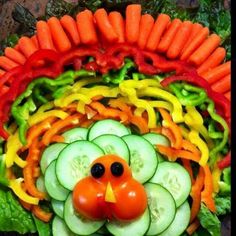 a head made out of carrots, cucumbers and peppers with a face on it