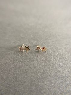 14K Solid Gold Tiny CZ Two Star Stud Earrings - 14K Solid Gold Quantity: One Pair Color : Gold Materials : 14K Solid Yellow Gold Size : 6mm*10mm *14K Solid Yellow Gold will not tarnish. *Good for sensitive skin. * Metal components are 14K Solid Yellow Gold including earring backs. * Suitable for delicate and sensitive ears. * Comes in a jewelry box. If you need extra boxes for gifting....just let us know! Gold Star Earrings With Diamond Accents, Gold Star-shaped Earrings With Diamond Accents, Gold Diamond Star Earrings, Star Stud Earrings, Star Earrings Stud, Cz Stud Earrings, Cartilage Piercing, Star Studs, Gold Price