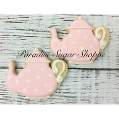 two decorated cookies in the shape of teapots