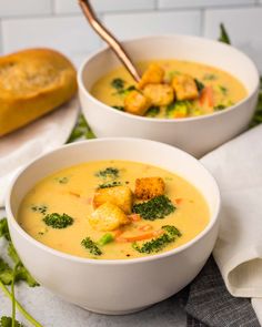 two bowls of soup with broccoli, cauliflower and croutons