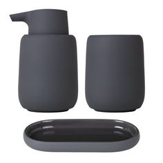 two gray soap dispensers sitting next to each other on a white background