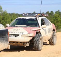 an off road vehicle driving on a dirt road