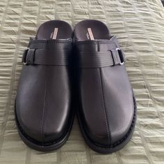 Collections By Clarks Soft Cushion Black Slip On Clogs Buckle On Side, Size 9 1/2, New Classic Slip-on Mules With Buckle Closure, Casual Business Mules With Leather Footbed, Business Clogs With Leather Footbed And Round Toe, Elegant Clogs With Cushioned Footbed And Round Toe, Elegant Cushioned Clogs With Round Toe, Elegant Round Toe Clogs With Cushioned Footbed, Black Closed Toe Slip-ons With Leather Footbed, Formal Leather Clogs With Cushioned Footbed, Black Leather Open Toe Slip-ons