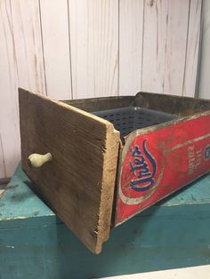 an old coca cola crate sitting on top of a table