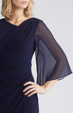 Exude classic elegance in a navy-blue gown designed with frothy sheer sleeves and shaped with delicate ruching. 58" length Slips on over head Asymmetric neck Bracelet-length sleeves Lined, except sleeves 96% polyester, 4% spandex body with 100% polyester sleeves Hand wash, dry flat Imported Neck Bracelet, Ruched Gown, Navy Blue Gown, Chiffon Cape, Blue Gown, Cape Sleeves, Gowns With Sleeves, Sheer Sleeves, Classic Elegance