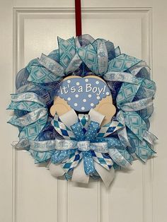 a blue and white wreath that says it's a boy on the front door