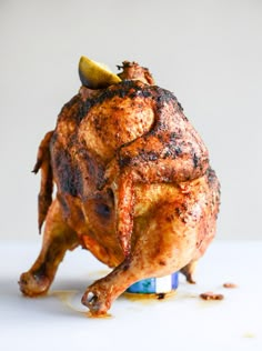 a whole chicken sitting on top of a blue and white plate