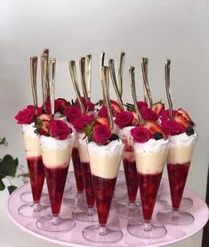 there are many desserts with strawberries in them on the cake platter,