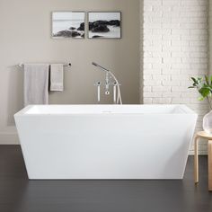 a white bath tub sitting inside of a bathroom