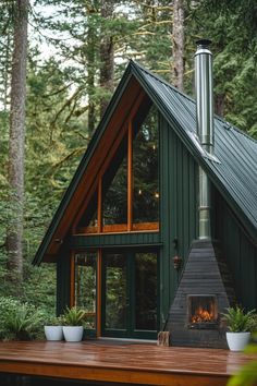 a small cabin with a fire place in the front and two potted plants on the outside