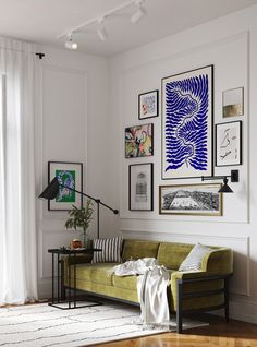 a living room filled with furniture and pictures on the wall