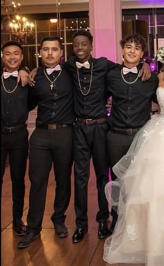 a group of people standing next to each other in front of a mirror at a wedding