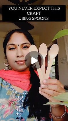 a woman holding up wooden spoons in her hand with text that reads, you never expect this craft using spoons