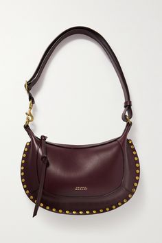 Isabel Marant's 'Oskan Moon' bag is perfect for carrying everyday necessities. Crafted from burgundy leather, it has a curved shape that's outlined with gold-tone studs and is stamped with a matching foiled logo. Inside, there are two pockets to keep your belongings organized and secure. Body Furniture, Moon Shoulder Bag, Dream Bags, Moon Bag, Moon Studs, Roger Vivier, Winter 2023, Studded Leather, Dries Van Noten