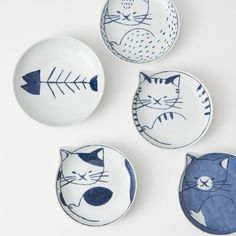 three plates with cats and fish designs on them