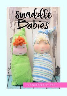 two small dolls sitting next to each other on top of a wooden floor with the words swaddle babies written above them