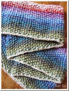 three crocheted dishcloths sitting on top of a wooden table