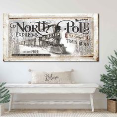 a white bench sitting in front of a wall with a sign on it that says north pole express