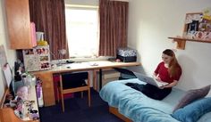 a woman sitting on top of a bed using a laptop computer