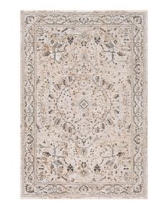 a beige rug with an intricate design on it