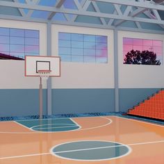 an indoor basketball court in front of windows