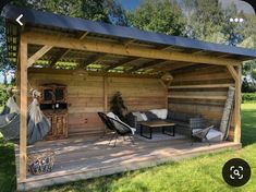 an outdoor living area with couches, chairs and a hammock hanging from the roof