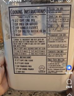 a person holding a container with instructions for cooking in it on top of a counter