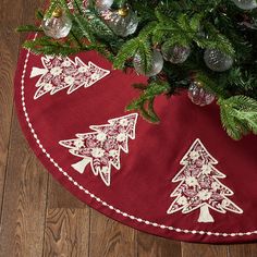 a christmas tree skirt with ornaments on it