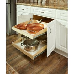 an open cabinet with pots and pans in it