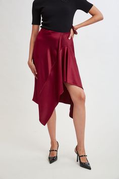 Indulge in the fluid elegance of our Asymmetric Hem Satin Midi Skirt. The skirt drapes beautifully and moves gracefully with every step, adding a dynamic touch to your look. We love it paired with cashmere for a dressed down vibe to dressing up. Limited Edition 50th Anniversary Collection Elie Tahari Exclusive Satin Asymmetric Hem Midi Skirt 100% Polyester Runs true to Size Length From Waist to Hem: Back 28.2"L (approx. length for size 6) Model is 5'9" and wearing size 2 Dry Clean Only Imported Skirt Draping, Tahari Dress, Satin Midi Skirt, Long Sleeve Short Dress, Elie Tahari, Knit Tees, Denim Coat, Knit Jacket, Skirts For Sale