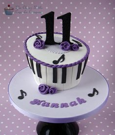 a birthday cake decorated with musical notes and the number one on it's top