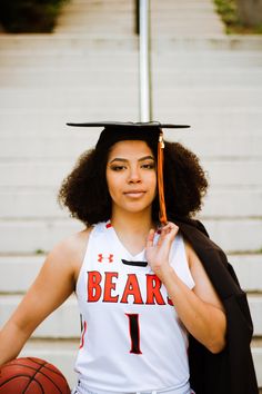 a female basketball player in her cap and gown