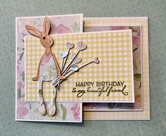 a birthday card with an image of a bunny holding flowers