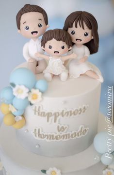 a white cake with three figurines on top