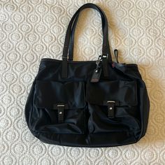 Great Condition Authentic Tumi Bag, No Stains, Tear Or Wear. Leather Straps, Multiple Compartments, Luggage Tag Strap To Secure Over Luggage Handle. Great For Travel Or Work As It Fits Up To A 16 Inch Laptop Too! (Computer Mouse For Size) 16” X 13” X 5” Black Nylon Shoulder Bag For Errands, Elegant Nylon Tote Shoulder Bag, Elegant Nylon Tote Bag, Elegant Nylon Shoulder Bag For Shopping, Elegant Nylon Bag For Everyday Use, Elegant Everyday Nylon Bag, Elegant Nylon Bag For On-the-go, Nylon Satchel With Leather Handles, Elegant Nylon Travel Bag