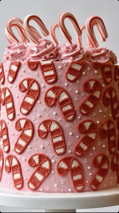 a pink cake decorated with candy canes and candies