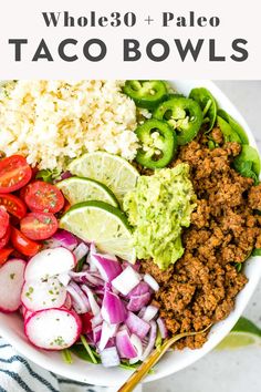 a white bowl filled with taco bowls and vegetables