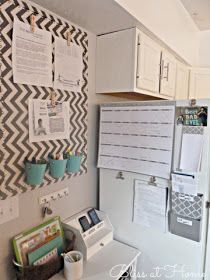 a white refrigerator freezer sitting inside of a kitchen next to a wall mounted bulletin board