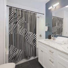 a bathroom with a black and white shower curtain