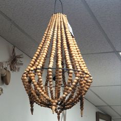 a wooden bead chandelier hanging from the ceiling